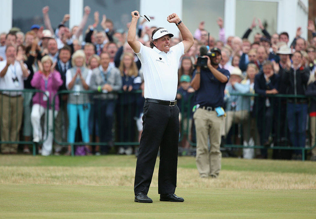 Phil Mickelson celebrates a birdie on the 18th, which sealed his Open victory at Muirfield